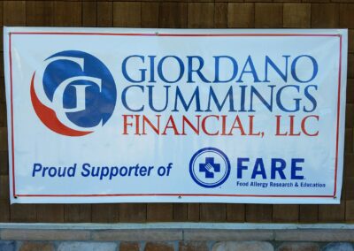 a sign that says "Giordano Cummings Financial, LLC, Proud Supporter of FARE, Food Allergy Research & Education