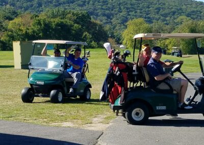 happy men in golf carts