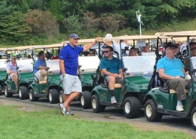 people in green golf carts