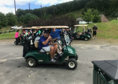 people in green golf carts