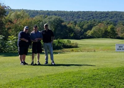 three men on a golf course