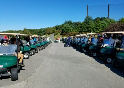 people in green golf carts