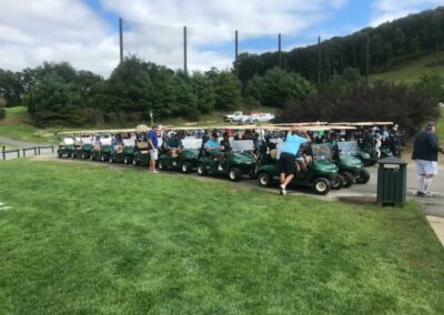 people in green golf carts