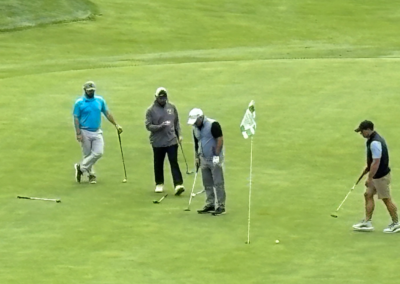four men golfing